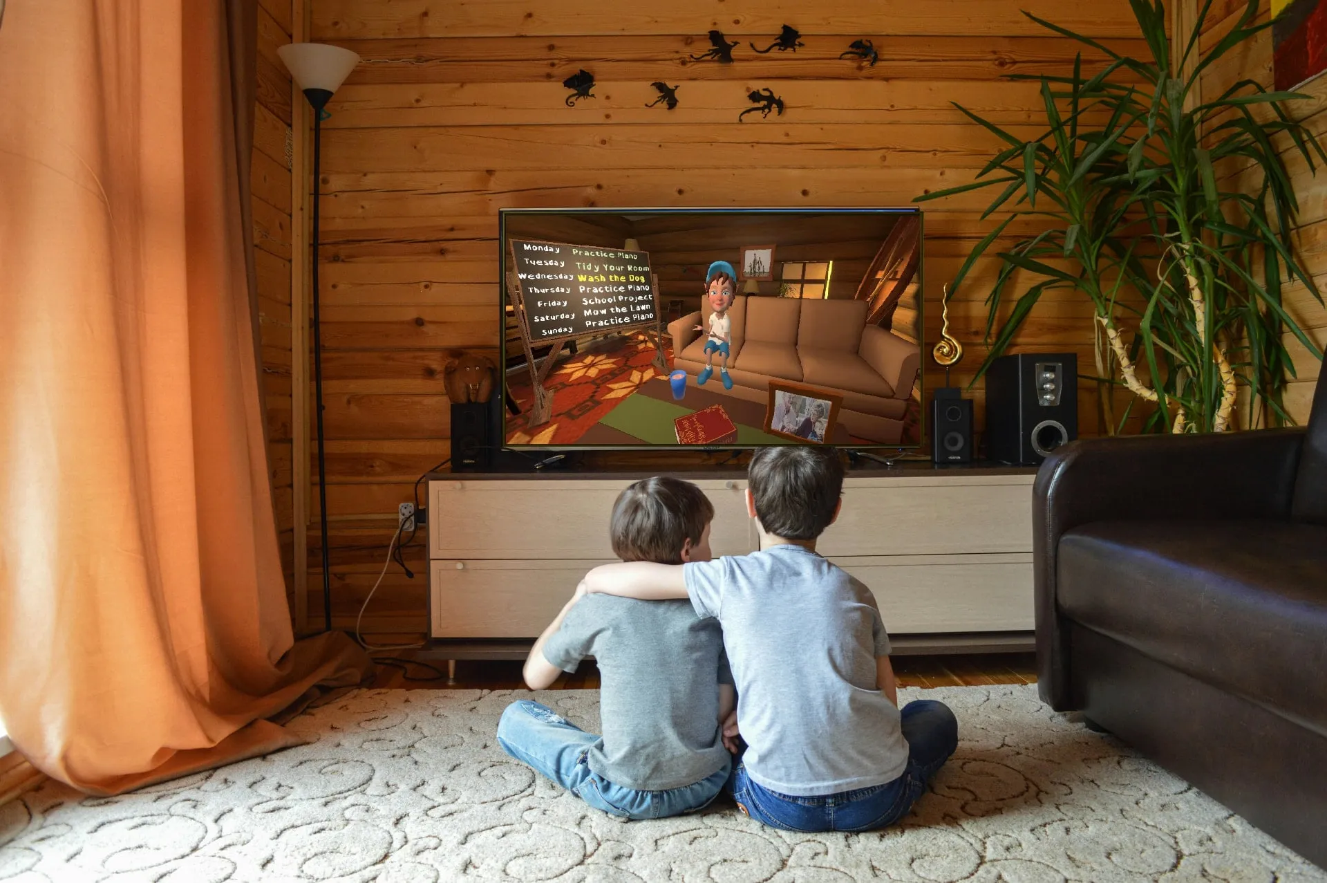 Two children watching Chuck present the task board on their television